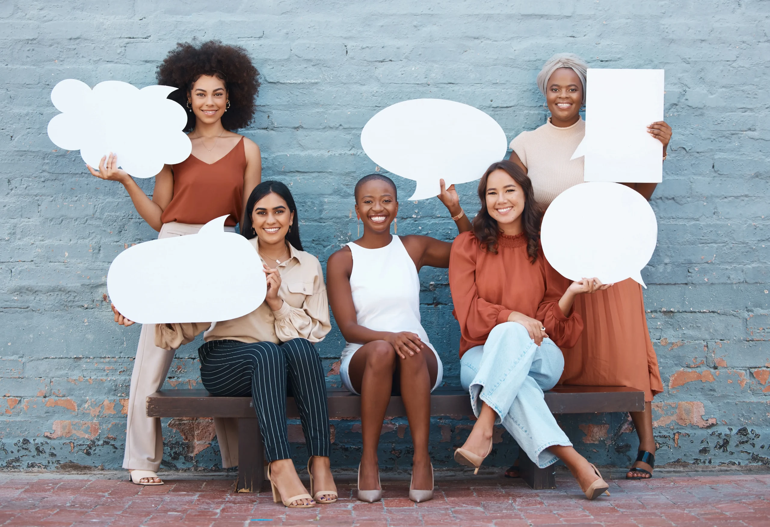 group of five young happy cheerful women holding comments