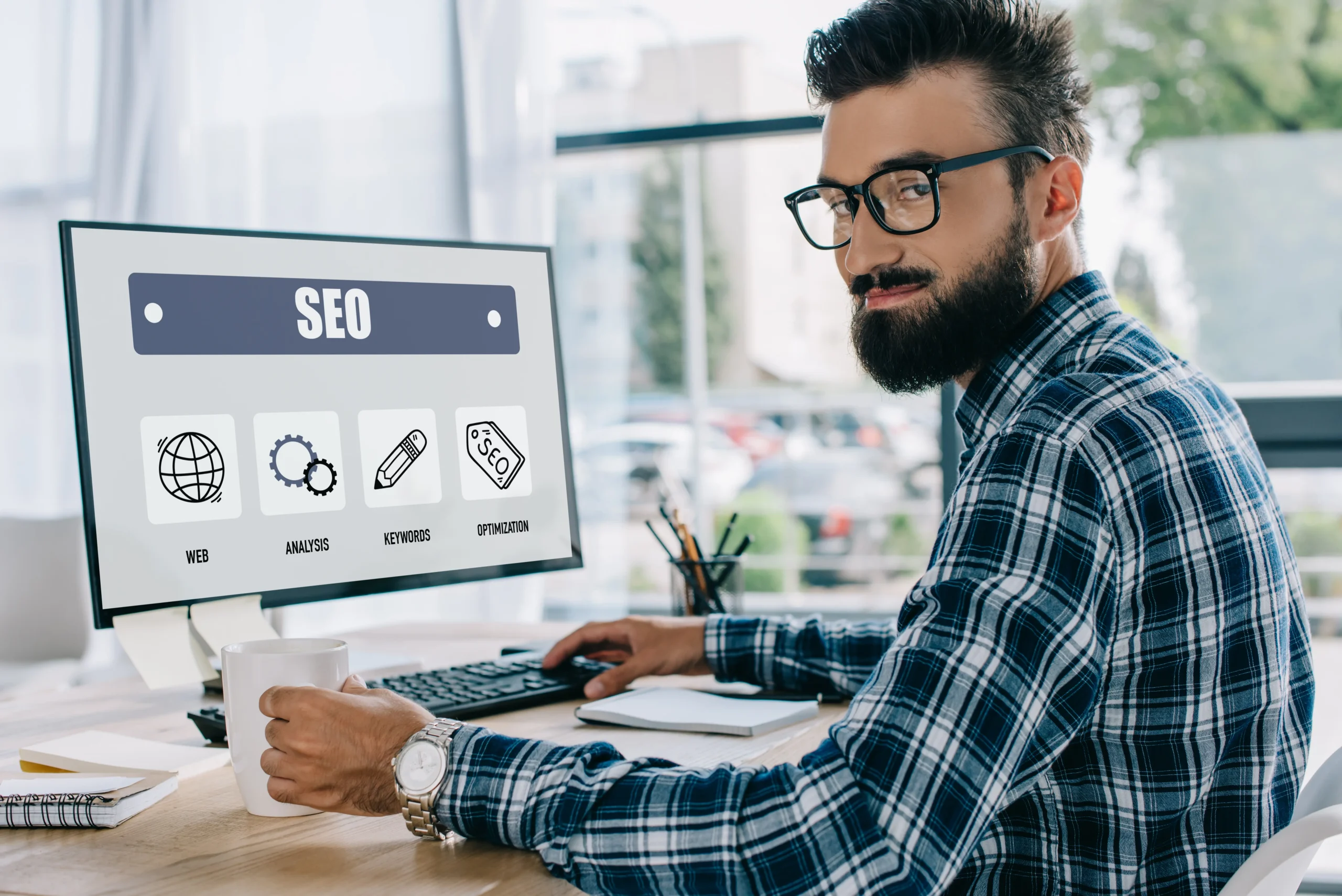 young successful seo manager sitting at workplace